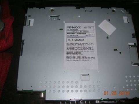 1985 Ford Bronco - This Kenwood CD receiver part has a label with manufacturing information and a serial number.