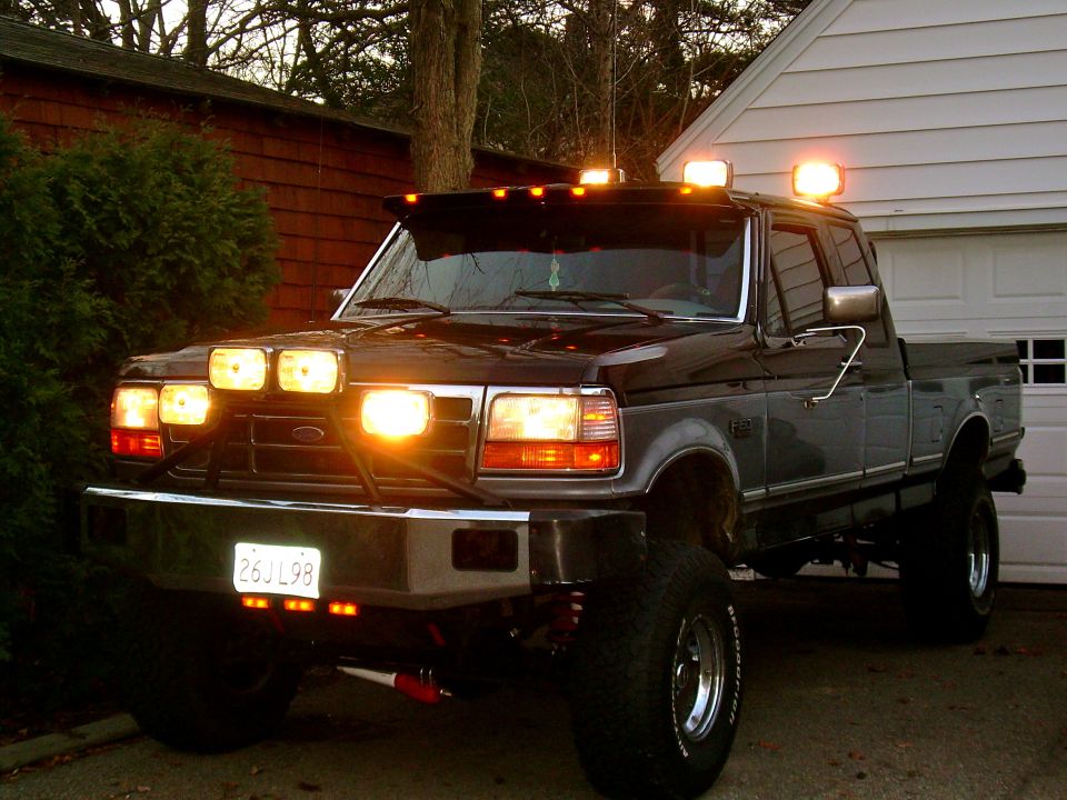 Black Ford F-150 pickup truck with extra lights on the front and roof