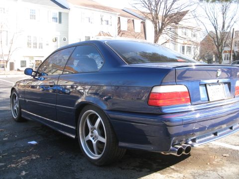 1994 Ford Probe - This blue coupe features a distinctive body style and dual exhaust pipes.