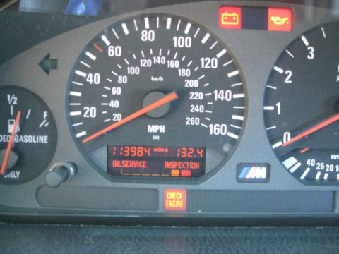 1994 Ford Probe - The dashboard displays mileage, oil service, and inspection reminders, along with a check engine light.