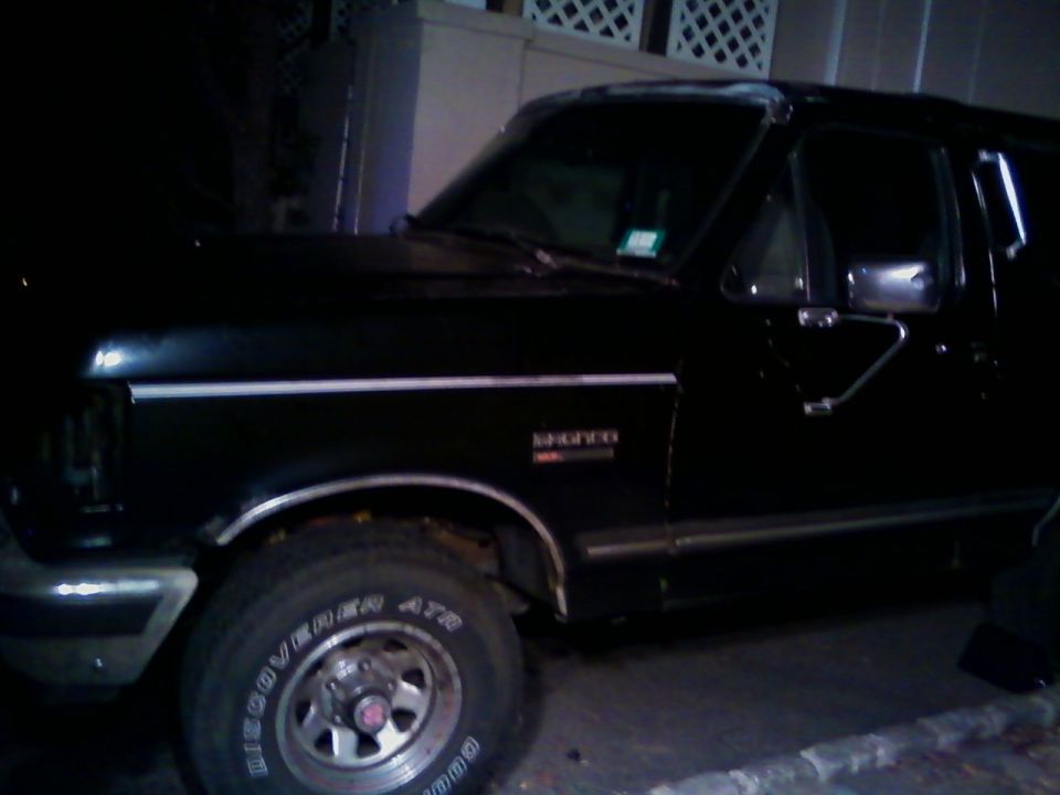 Black Ford Bronco parked at night, driver side view with BFG All-Terrain tires