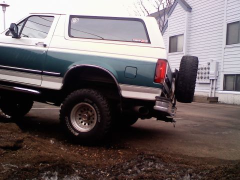 1996 Ford Bronco - This 1996 Ford Bronco is shown from the rear, its distinctive two-tone green and white paint scheme and a rear-mounted spare tire.