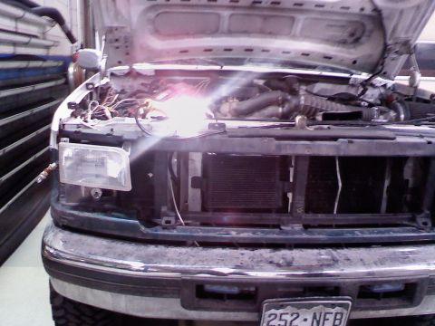 1996 Ford Bronco - To get the everything off that is off in the pic, the access to the bolts you need is thru a small hole in the core support. behide the hea…