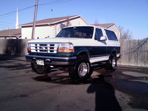 1996 Ford Bronco - This lifted Ford Bronco is parked in a driveway on a sunny day.