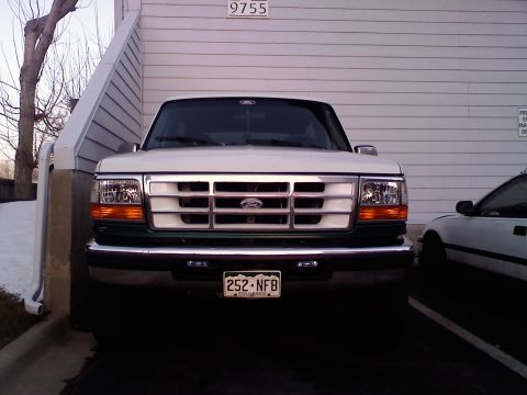 1996 Ford Bronco - Front view of a 1996 Ford Bronco parked next to another vehicle.