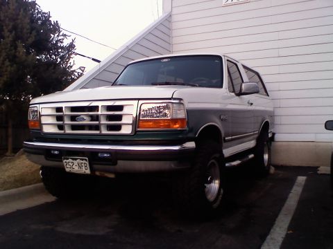 1996 Ford Bronco - This two-tone Ford Bronco is parked in a driveway, showing its front-right side.