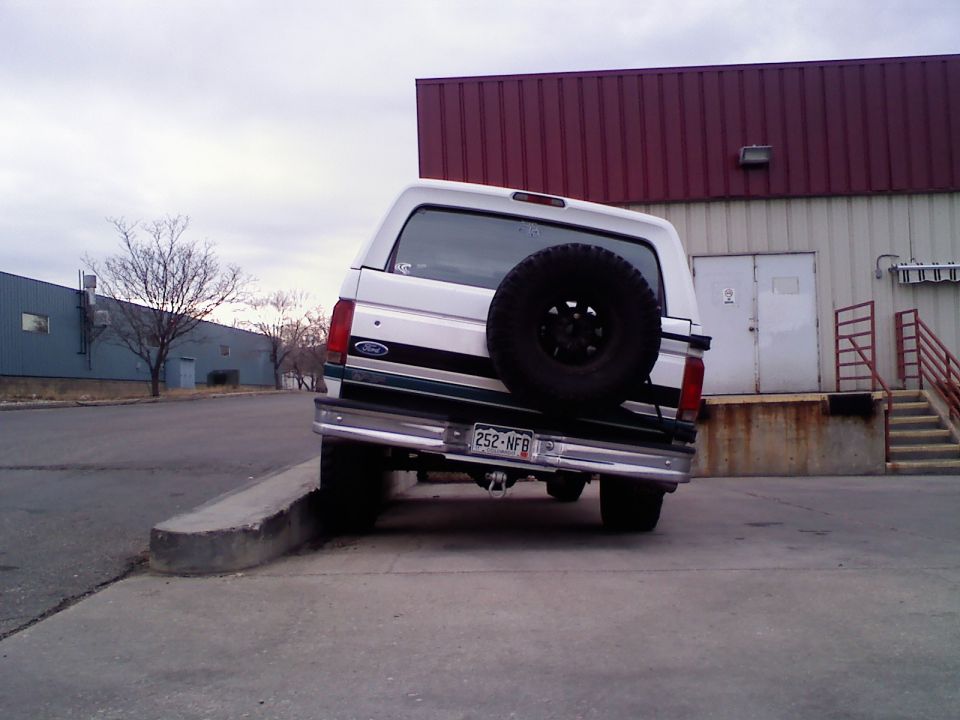 1996 Ford Bronco rear view, parked with rear wheels on curb
