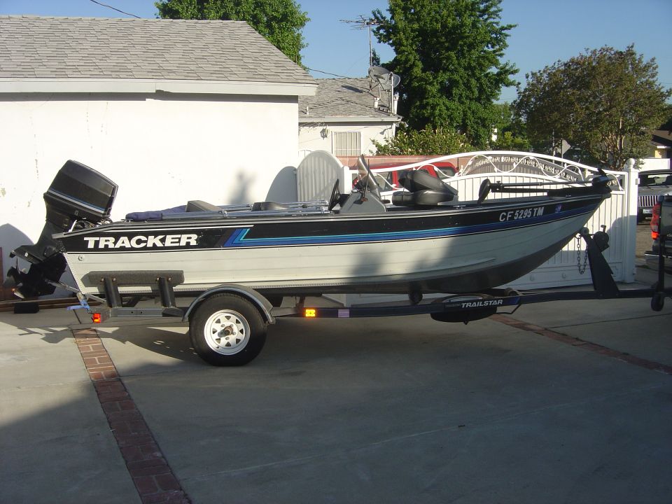 Tracker boat with registration CF 5285 TM on a Trailstar trailer parked on a driveway