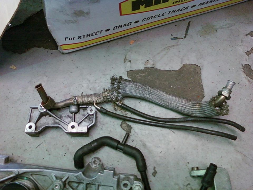 Engine part with heat-shielded hose and rubber lines