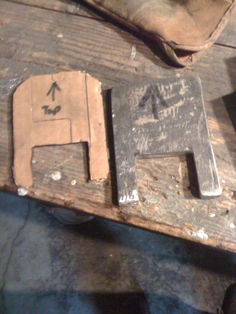 1989 Ford Bronco - Two templates, one paper and one metal, are laid out on a wooden surface, possibly for crafting or repair.