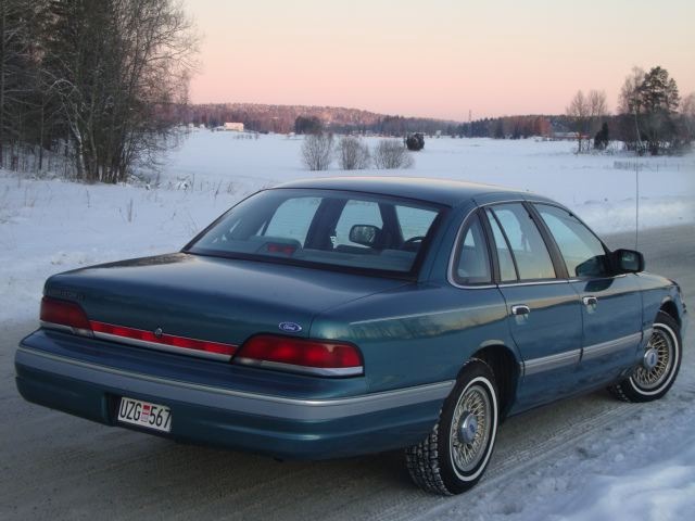 1993 Ford Crown Victoria, rear view, parked on a snowy road