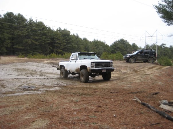 White pickup truck with large tires off-road