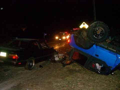 1996 Ford Bronco - A nighttime accident scene shows an overturned blue Jeep and a damaged black sedan.