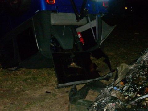 1996 Ford Bronco - The interior of a damaged blue SUV is visible, with a fire extinguisher mounted inside.
