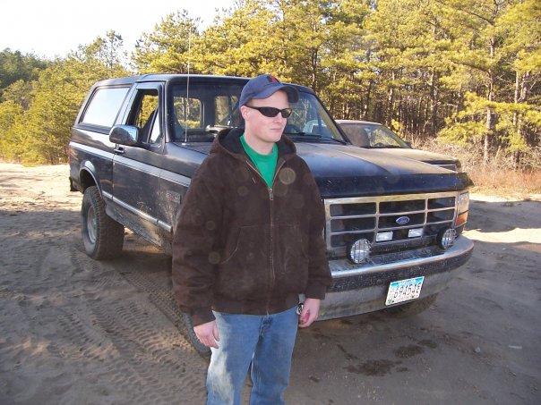 Black 1994 Ford Bronco front 3/4 view with person