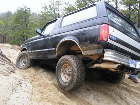 1994 Ford Bronco - This 1994 Ford Bronco is navigating a sandy incline, its off-road capabilities.