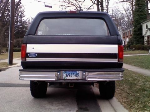 1994 Ford Bronco - This 1992 Ford Bronco is seen from the rear, a distinctive stripe and license plate.