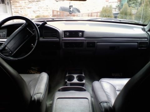 1994 Ford Bronco - The interior of a Ford Bronco, likely from the early to mid-1990s, is visible from the perspective of the driver's seat.