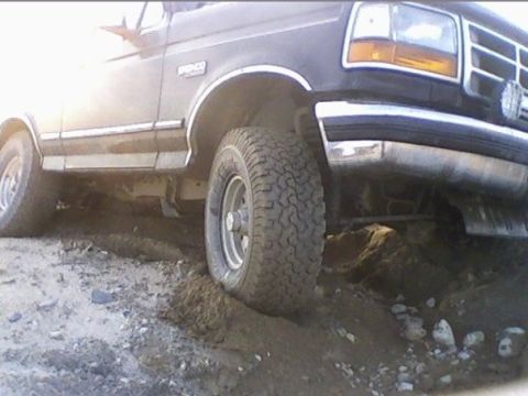 1994 Ford Bronco - This 1994 Ford Bronco is navigating a rough, uneven dirt path.