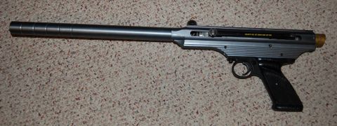 1994 Ford Bronco - Silver air pistol with black grip is shown on a carpeted surface. Text from a watermark is visible.