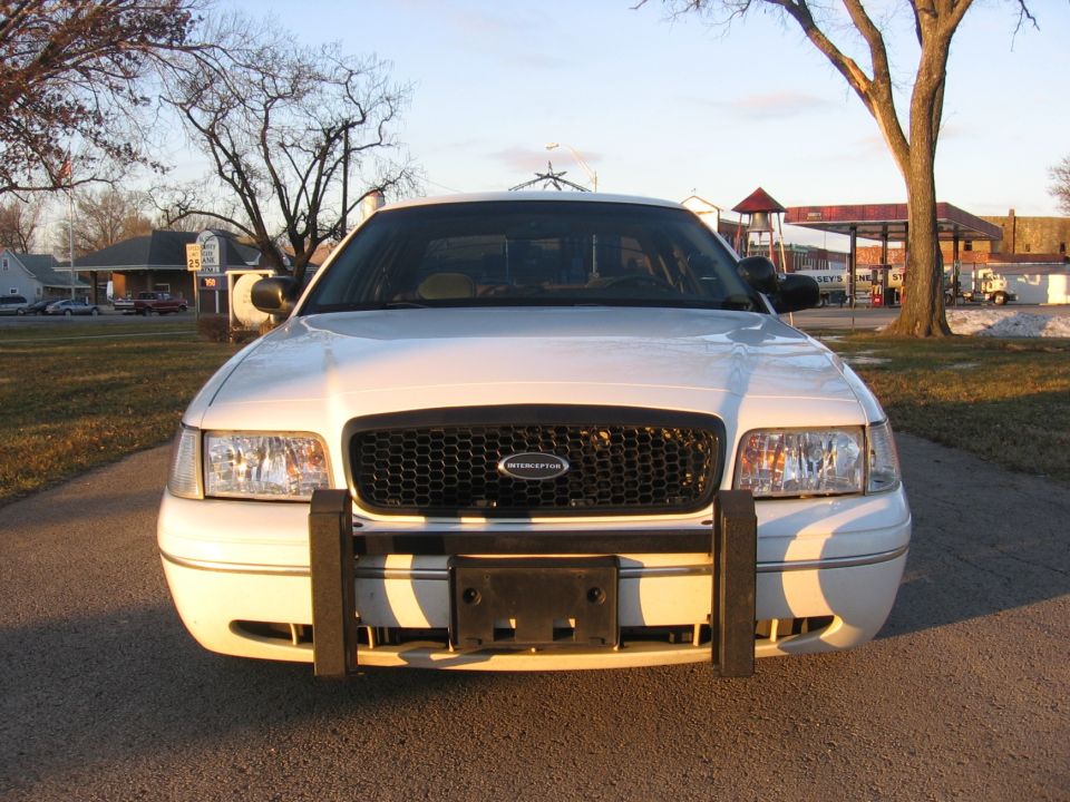 White Ford Crown Victoria Police Interceptor with push bumper, front view