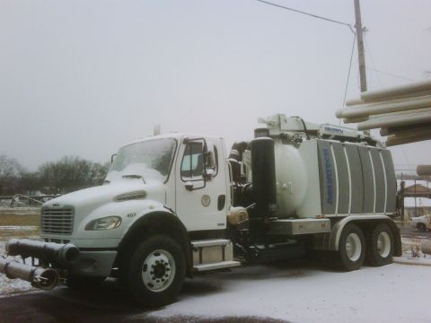 2007 Ford Mustang - Vacuum truck with "AQUATECH" branding seen in snowy conditions, with pipes stacked nearby.