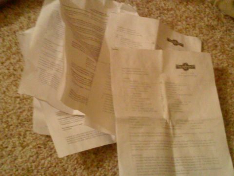 1995 Ford Bronco - A pile of papers with text and logos is spread out on a carpeted surface.