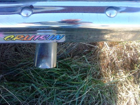 1995 Ford Bronco - A sticker reading 'CRUISIN' is affixed to a chrome bumper above an exhaust pipe.