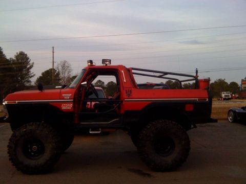 1979 Ford Bronco - This modified 1979 Ford Bronco features a prominent roll cage and oversized off-road tires.