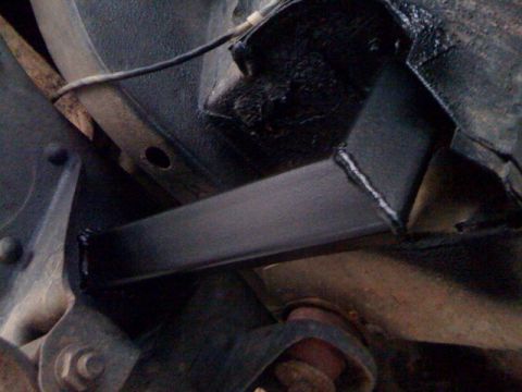 1979 Ford Bronco - Custom metalwork is visible on the underside of a vehicle, possibly for structural support.