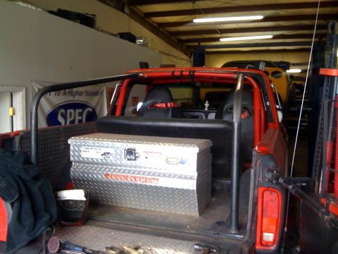 1979 Ford Bronco - Interior view of a modified off-road vehicle with a prominent roll cage and a toolbox.