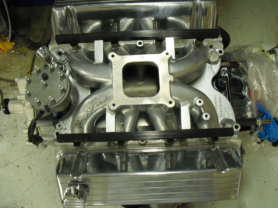 Polished aluminum V8 intake manifold with square carb flange and polished valve covers, top view