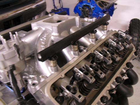 1996 Ford Bronco - Close-up view of an engine's fuel rail and exposed valve train components.