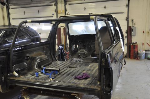 1996 Ford Bronco - Interior view of a 1996 Ford Bronco undergoing modifications, with a roll cage fitted.