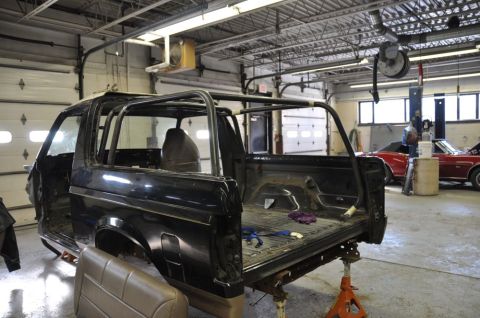 1996 Ford Bronco - This 1996 Ford Bronco is undergoing work in a garage, with another vehicle visible.