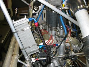 1993 Ford Taurus - Close-up of a modified engine compartment, showing an oil cooler and plumbing.