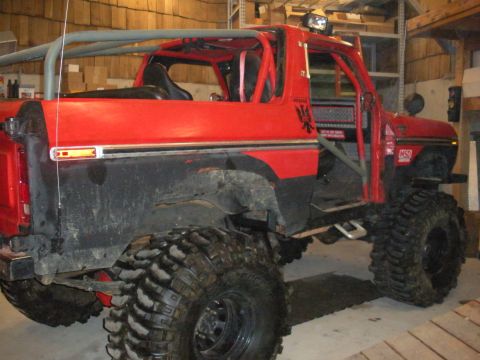 1979 Ford Bronco - This heavily modified SUV features a prominent roll cage and oversized tires, suggesting it's built for off-road use.