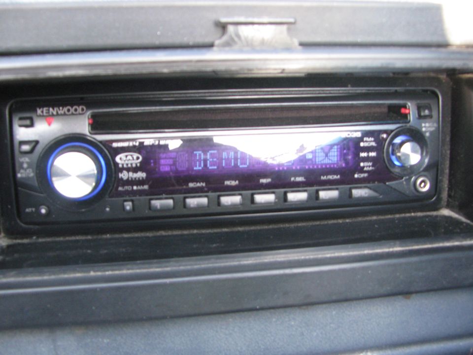 Kenwood CD MP3 head unit in black dash showing DEMO on its purple display