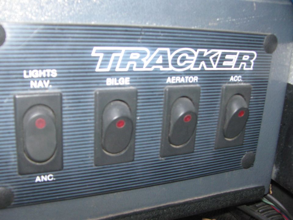 Tracker boat console rocker switch panel labeled nav lights, bilge, aerator and accessory