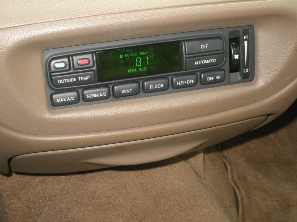 Ford EATC automatic climate control panel in tan dash showing 81 degrees and MAX A/C