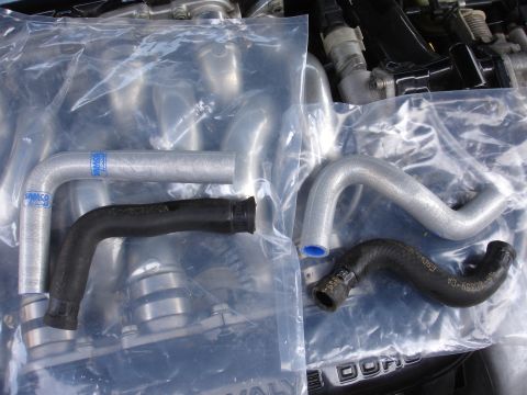 1993 Ford Taurus - New radiator hoses are packaged and ready for installation on an engine.