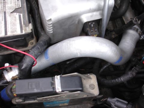 1993 Ford Taurus - Engine bay components including battery, hoses, and electrical connectors are visible in this close-up shot.