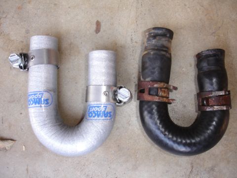 1993 Ford Taurus - Comparison of a new silver Samco Sport radiator hose with an old black rubber hose, both with hose clamps.