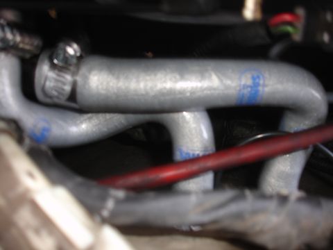 1993 Ford Taurus - Silver engine hoses with blue markings are visible, along with a red wire and other engine components.