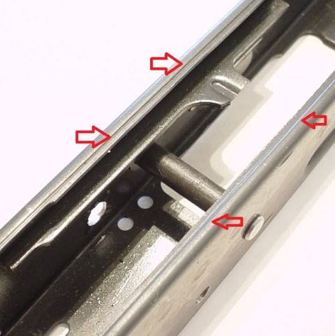 2000 Ford Crown Victoria - A close-up view of a metal component, possibly a bracket, with red arrows indicating specific areas. The Supermotors.net logo is present in…