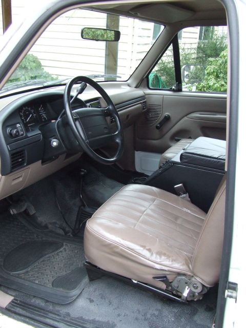 1996 Ford Bronco - The interior of a vehicle is shown, the driver's seat and dashboard.