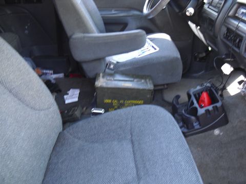 1992 Ford Bronco - The interior of a vehicle is shown, with an ammo can and other items on the floor.