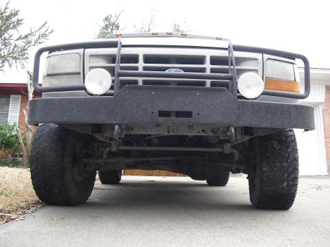 1992 Ford Bronco - Front view of a 1992 Ford Bronco with a bull bar and large tires.