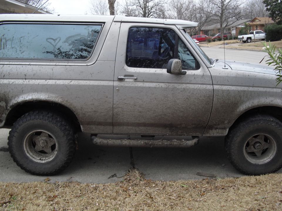 1992 Ford Bronco side view, covered in dirt