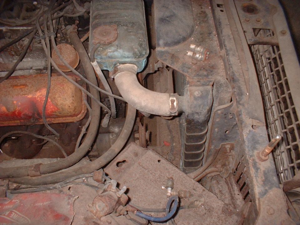 Engine bay showing radiator, hoses, and engine block